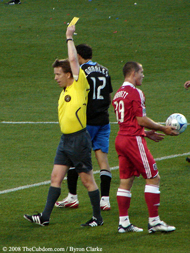 Andrew Chapin awards a yellow card